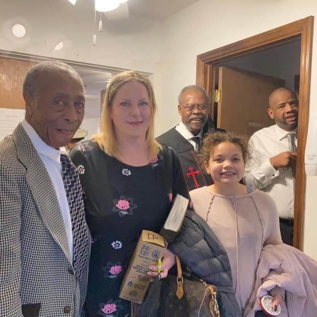 Church members and guests stand together after a service.