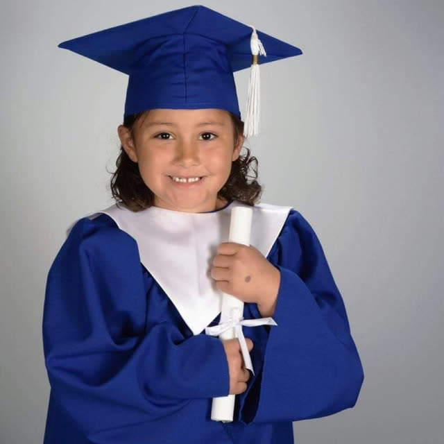 A young child in a blue graduation cap and gown.