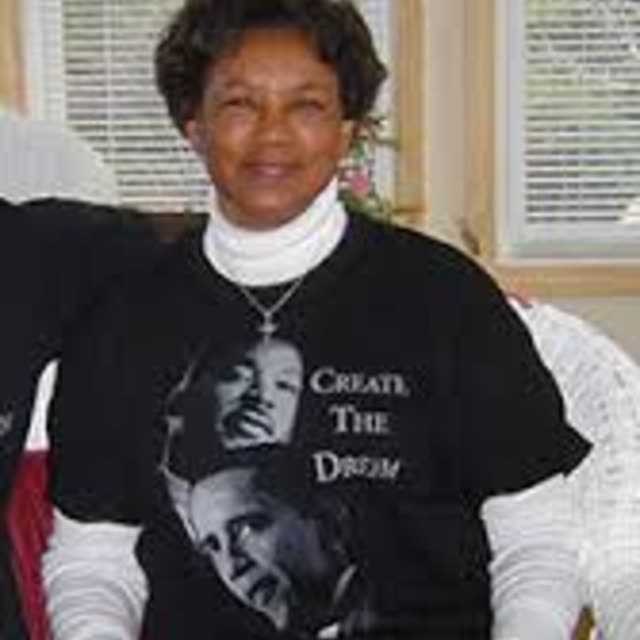 A woman in a black T-shirt with a printed design.