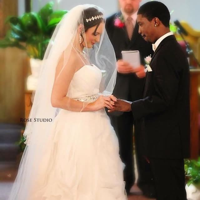 A bride and groom exchange rings.