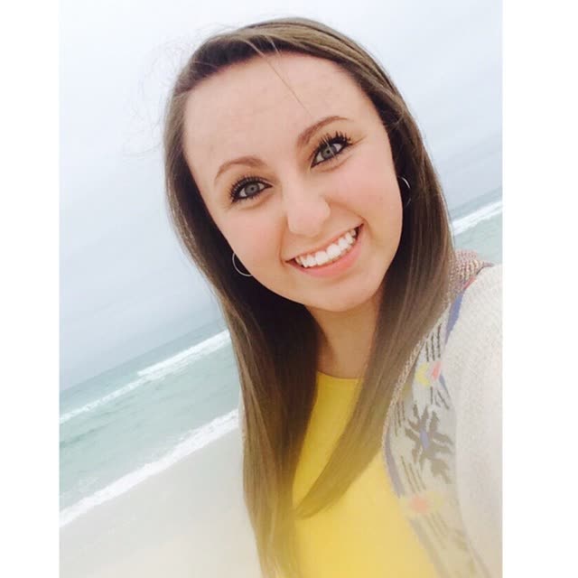 A smiling young woman with long hair.