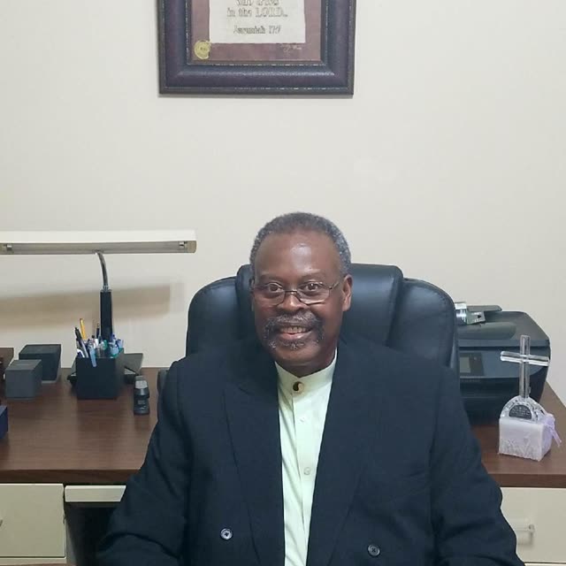 Pastor Harbin seated at his desk in the pastor's study.