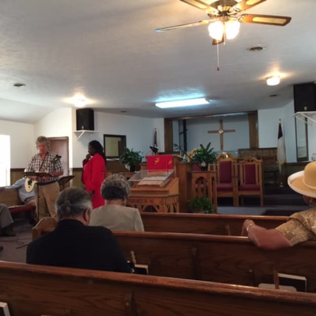 People seated in the pews of the sanctuary.