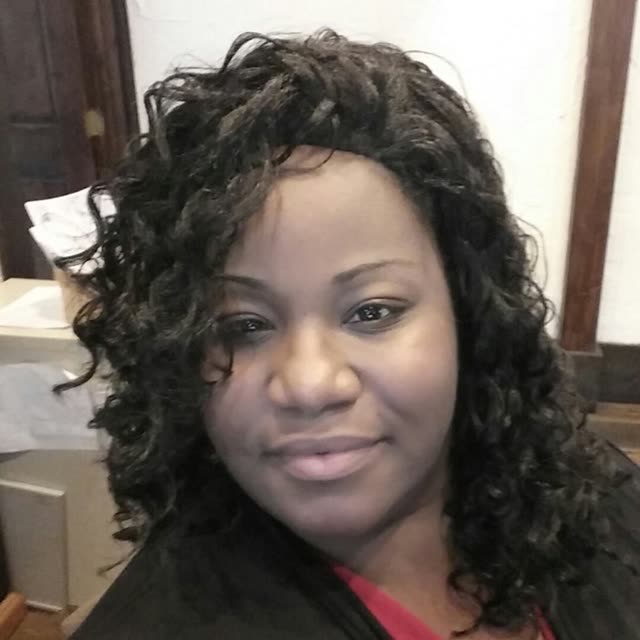 A woman with long curly hair.