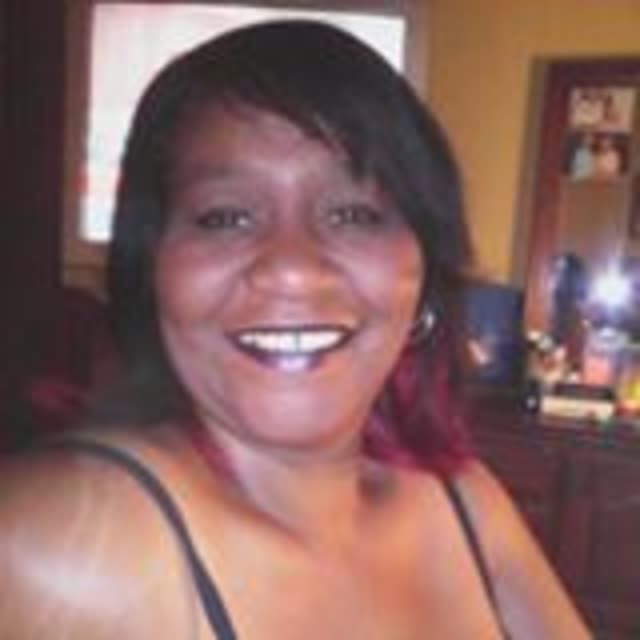 A smiling woman indoors.